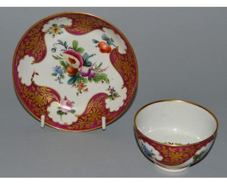 AN 18TH CENTURY WORCESTER TEA BOWL AND SAUCER painted in Hope Edwards style with fruits and vegetable under highly gilt clare