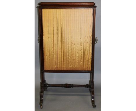 A REGENCY MAHOGANY FIRESCREEN with sliding silk work panels. 3ft 4ins high x 1ft 11ins wide.