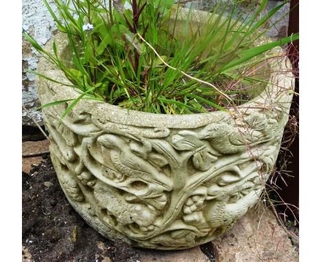 A SMALL RECONSTITUTED STONE GARDEN PLANTER with moulded decoration 8ins high.
