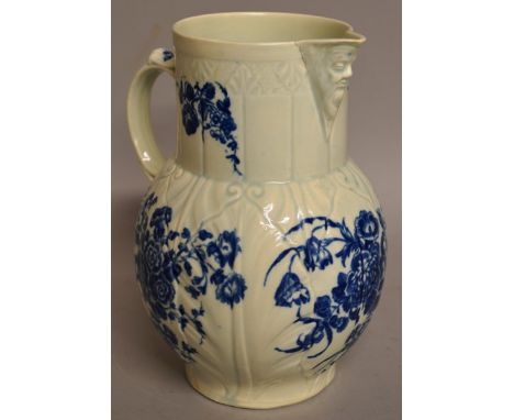AN 18TH CENTURY WORCESTER CABBAGE MOULDED MASK JUG decorated with flowers in under-glaze blue.