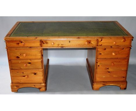 A GOOD PINE RECTANGULAR TOP PEDESTAL DESK with inset leather top, three frieze drawers, drawers to the pedestals with wooded 