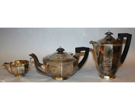 A TEN SIDED MATCHING TEAPOT, HOT WATER JUG AND MILK JUG with ebony handle and finial. Sheffield 1938 Maker: Walker & Hall Gro