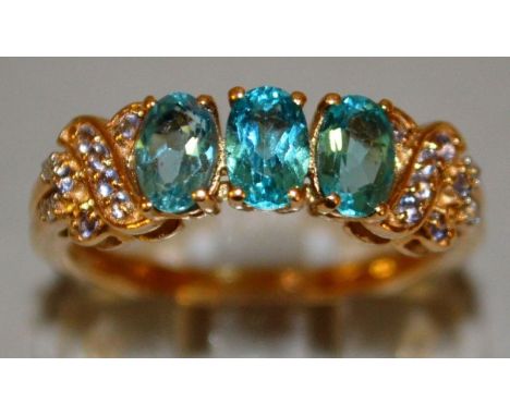 A GOOD THREE STONE TURQUOISE RING with diamond shoulders, set in 9ct gold.