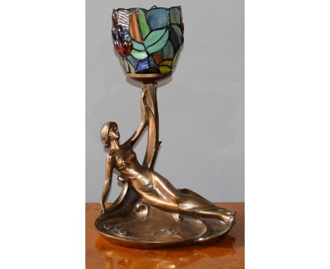 A TIFFANY DESIGN LAMP, reclining female with coloured leaded shade.