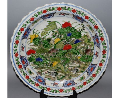 A LARGE CHINESE ENAMEL PLAQUE, flowers in multi-colours Bears six character mark 17ins diameter.