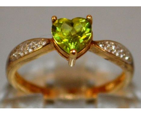 A GREEN STONE AND DIAMOND RING set in 9ct gold.