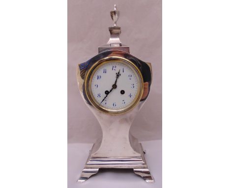 Mappin and Webb hallmarked silver mantle clock of shield form on stepped rectangular base with four bracket feet the white en