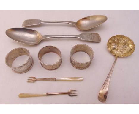A quantity of hallmarked silver to include two spoons, three napkin rings and a pair of pickle forks with Mother of Pearl han