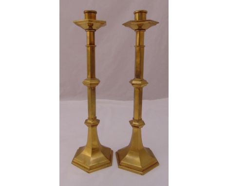 A pair of Victorian brass candlesticks of rectangular form on raised square bases and a brass carriage clock of customary for