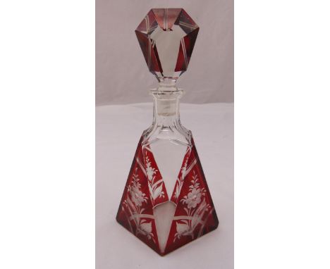 An Art Deco overlaid ruby glass decanter of geometric form etched with flowers and leaves and drop stopper, 24.5cm (h)