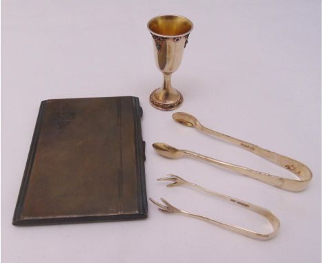 A hallmarked silver engine turned cigarette case, two pairs of hallmarked silver sugar tongs and a white metal Kiddush cup, a