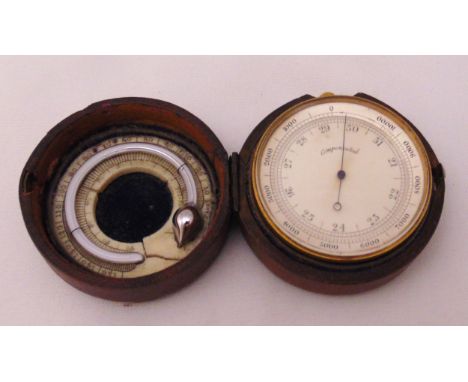 A travel barometer and thermometer in fitted leather case