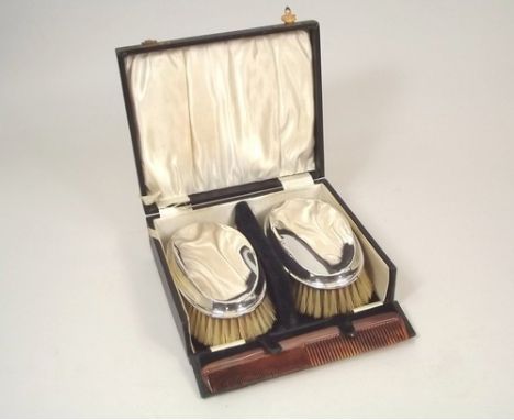 SILVER BRUSHES.
A pair of silver mounted hair brushes. London 1927. With comb, cased.