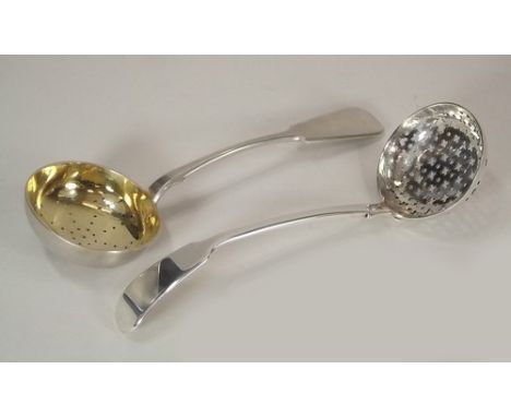 SIFTER SPOONS.
A George IV silver sifter ladle & an early 20th century Russian silver & silver gilt sifter spoon, the back wi