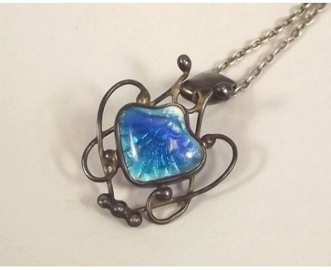 NEWLYN ENAMEL.
A Newlyn silver & enamel pendant of typical shell form, with turquoise blue & white enamelling, within a scrol