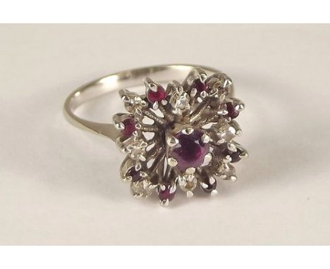 RUBY  & DIAMOND RING.
An 18ct. white gold flower head dress ring, set rubies & diamonds.