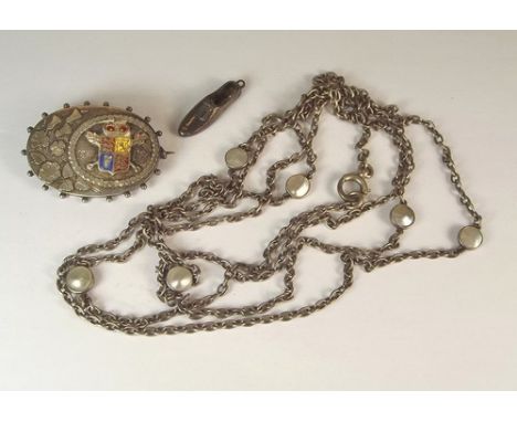 VICTORIAN BROOCH ETC.
A Victoria Golden Jubilee silver & enamel brooch, a long chain set with blister pearls & a silver shoe 