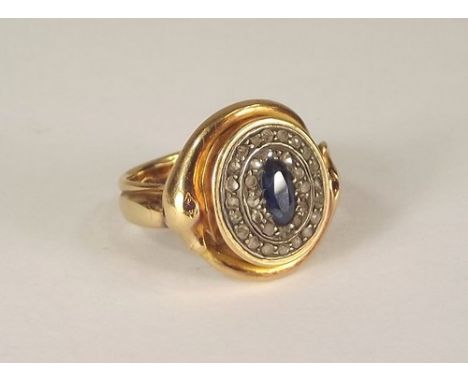 GOLD RING.
A 19th century substantial gold ring, set a sapphire & old cut diamonds within a ruby set serpent border. Approx. 