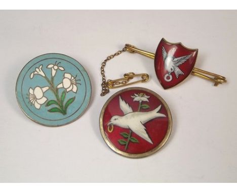 ENAMEL BADGES.
A 9ct. gold red & white enamelled shield bar brooch & two enamelled silver brooches.
