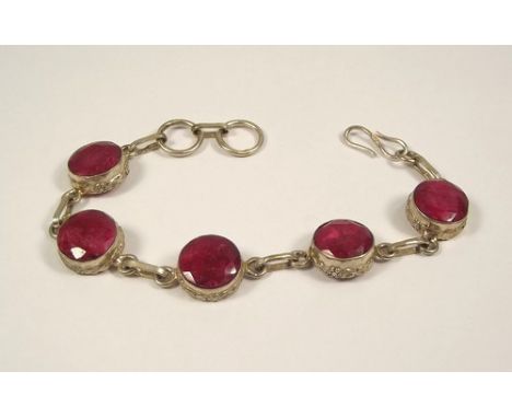 RUBY BRACELET.
A hand made silver bracelet with five facet cut rubies, in rub-over settings.