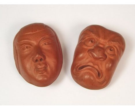 NOH MASKS.
Two Japanese redware Noh masks, each 5cm, each back pierced, possibly as a button (?).