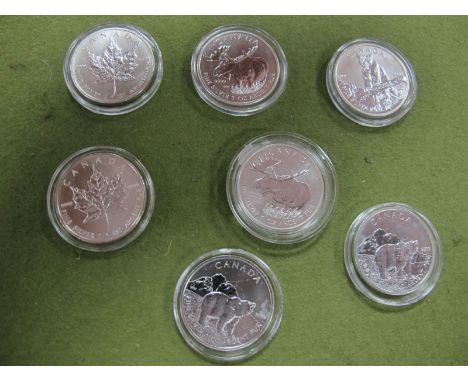 Seven Canadian One Ounce Five Dollars Silver Coins, including 2011 bear, 2010 maple leaf, all encapsulated. 