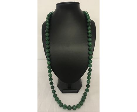 A 34" jade beaded necklace, knotted between each bead.  Beads approx. 1.25cm diameter.