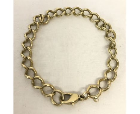 A 9ct gold curb chain bracelet with lobster clasp. Safety chain missing. Gold mark to each link. Total weight 30.3g approx.