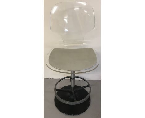 A vintage Lucite pedestal swivel bar chair. With beige leatherette seat and foot rest.  