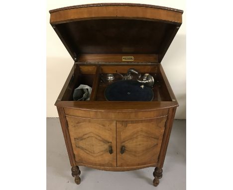 A vintage walnut cabinet gramophone by Mastertone. With turning handle. Restoration project. Approx 82cm tall by 61cm across.