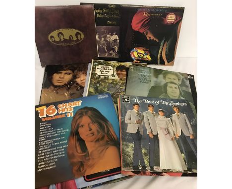 Approx. 30 Pop 12" Vinyl Records. To include: The Beatles, The Seekers, Electric Light Orchestra, The Bachelors and more. 