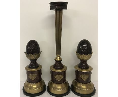A 3 piece vintage metal candle stand garniture on marble bases, with acorn detail. Candle stand has gilt decoration and colum