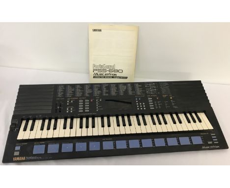 A vintage Yamaha Portasound PSS-680 Musicstation synthesizer with instruction manual.  