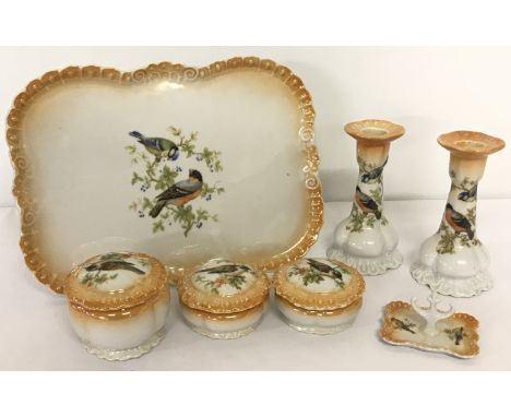 Victoria china 7 piece dressing table set with bird design. Comprising seven items: two candlesticks, three lidded jars (1 a/