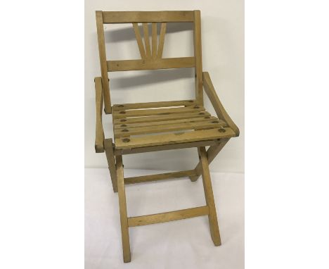 A vintage child's light wood folding chair. With slatted seat. Approx. 56cm tall.