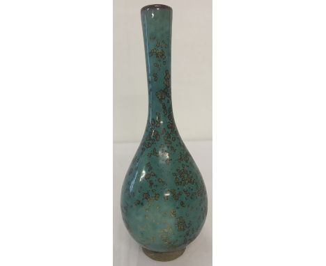 A slim necked Chinese ceramic vase with blue/green speckled glaze.  Approx. 22cm tall.