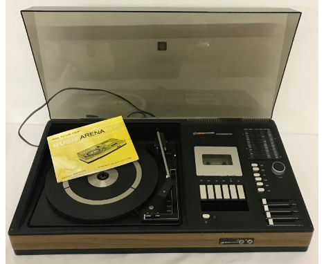 Bush Arena Hi-Fi Audiosystem 700 (Model BS3043). Includes record player, radio tuner and cassette player. Includes dust cover