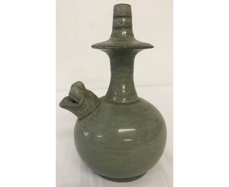 A Chinese ceramic green glazed pot with foo dog head shaped spout.  Approx. 19cm tall.