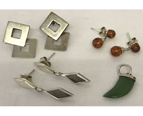 3 pairs of silver and white metal modern design earrings to include amber. Together with a small jade, animal tooth shaped pe