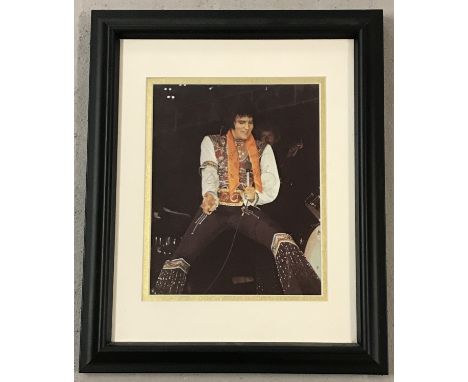 A framed and glazed signed colour photographic print of singer Elvis Presley complete with CAO. Certificate to rear of frame,