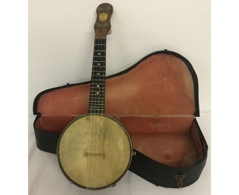 A vintage Dulcetta B.S 4 stringed banjolele in original carry case. One peg missing. 