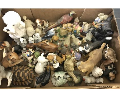 A large collection of ceramic and resin animal figures. To include: bears, birds, cats, dogs and other animals. 