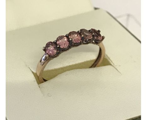 A 9ct gold ladies dress ring set with 5 oval cut pink stones.  Size N 1/2.