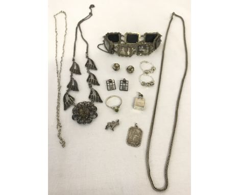 A collection of vintage silver and white metal jewellery. To include: a 7 panelled, carved shell bracelet set with marcasite 