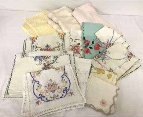 A collection of vintage linen items. To include embroidered tray liners and placemats. Together with three tablecloths. 
