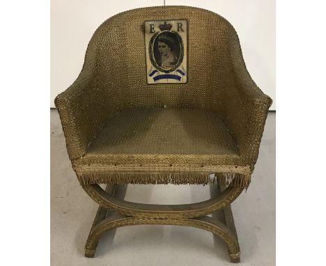 A child's vintage Lloyd Loom style chair. Painted gold, with a picture of Queen Elizabeth II to back. Approx. H54cm.