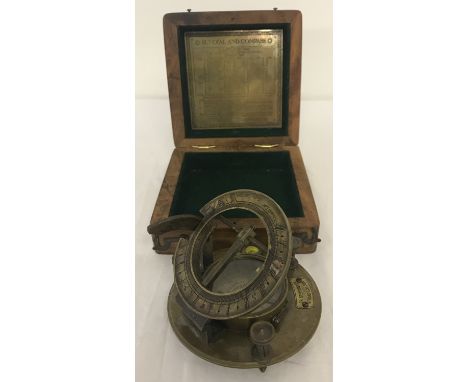 A brass sundial and compass in wooden box. Box and dial both marked "J.H.Steward Ltd, London". Box approx. 13.5cm x 14cm x 5.