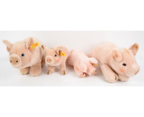 Four Steiff plush pigs, all with buttons in ears, smallest 22cm long, largest 31cm long,