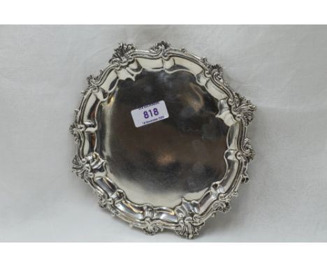 A Georgian silver card tray having decorative pie crust rim, trefoil hoof feet and bearing presentation inscription to base, 