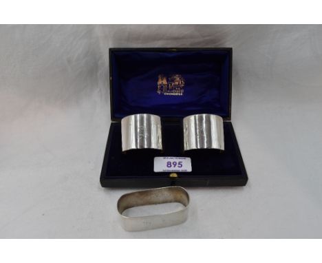 A cased pair of silver napkin rings of plain form bearing monogram A, Chester 1925, Barker Brothers, and another HM silver na